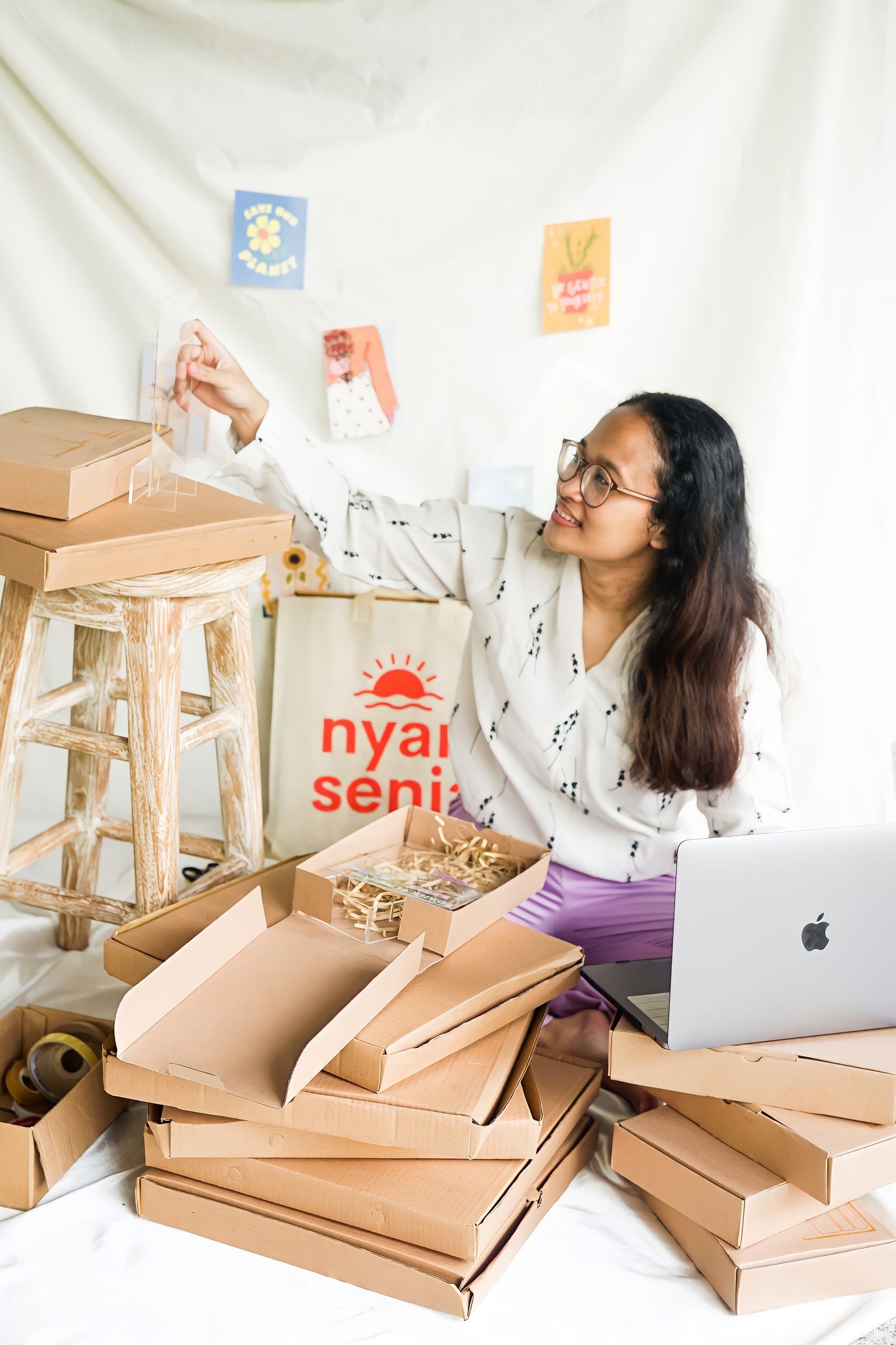 Small business owner packing ecommerce orders in a workspace