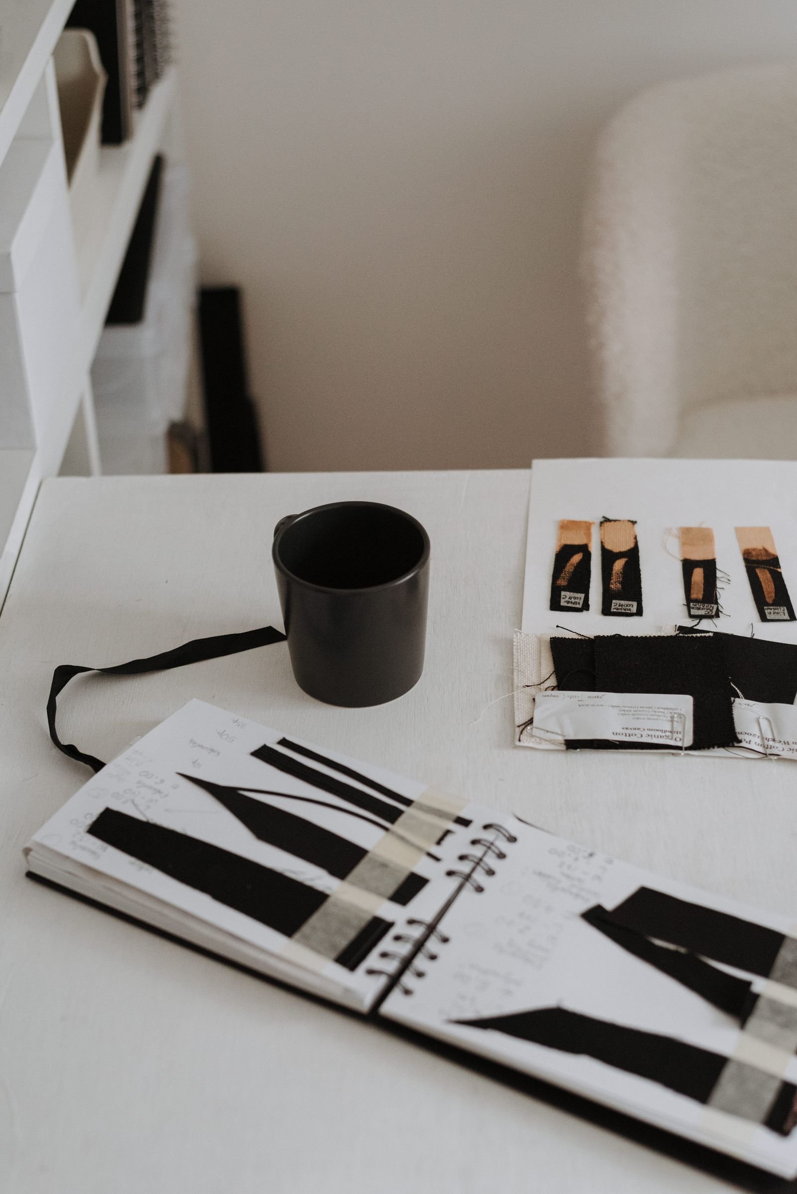 Fabric samples and sketchbook on a product development desk