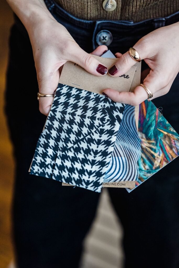 Hands comparing textile swatches
