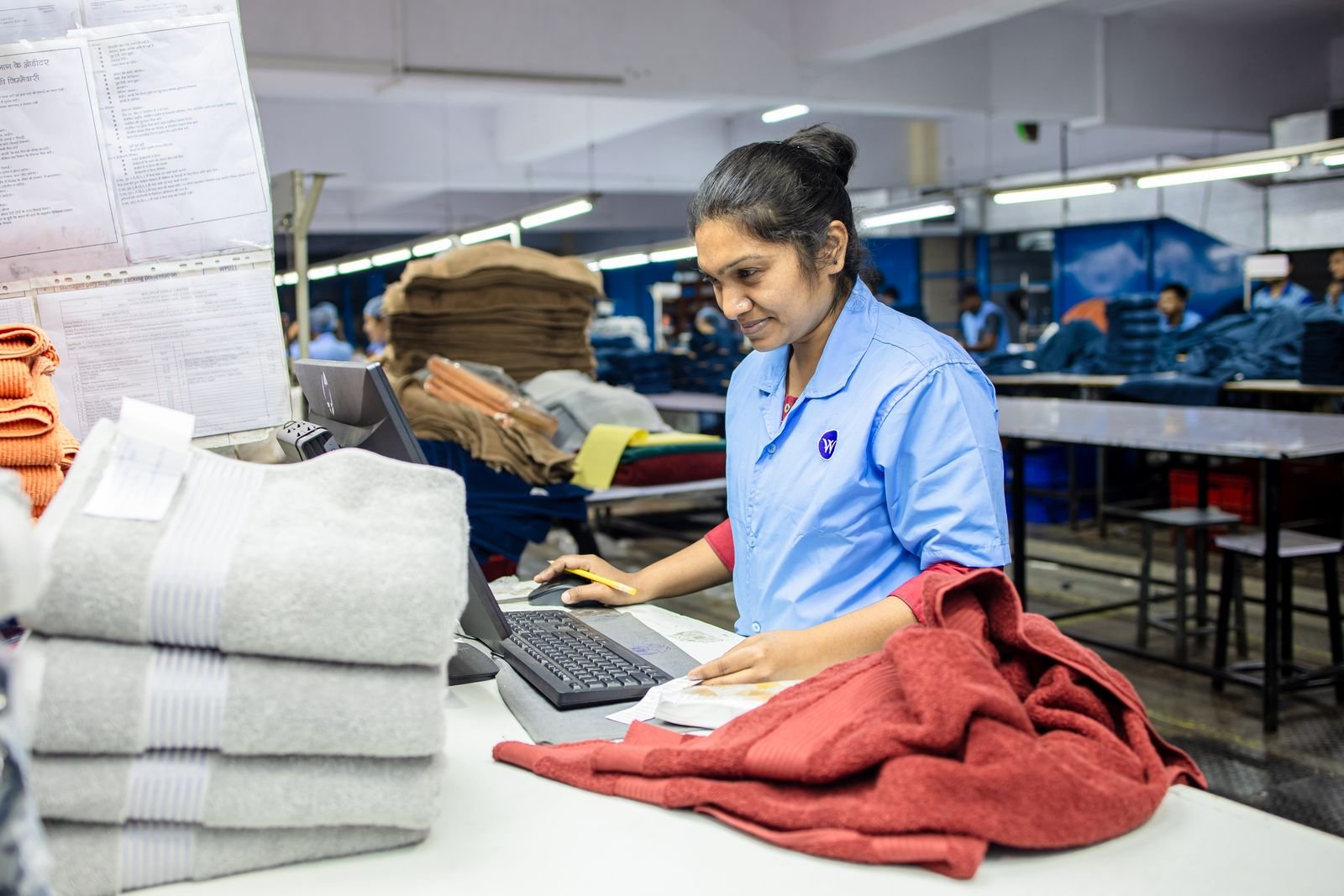 Textile factory worker inspecting fabrics during production